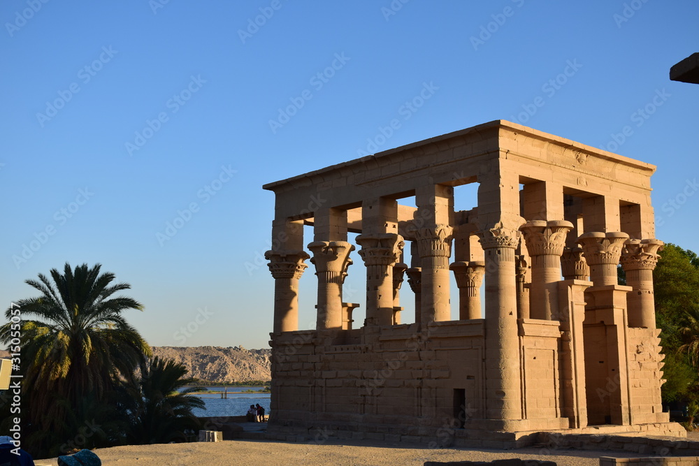 Fototapeta premium Ancient pharaohs Philae temple in Aswan Egypt in the river nile , old temple have hieroglyphs craved in its stones/Trajan's Kiosk / obelisk , Ancient Egypt Monuments 