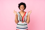 African american woman over isolated pink background in zen pose