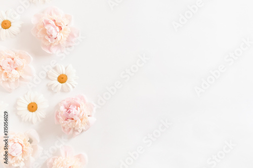 Pattern made of pink peonies and white chamomile flowers with copy space