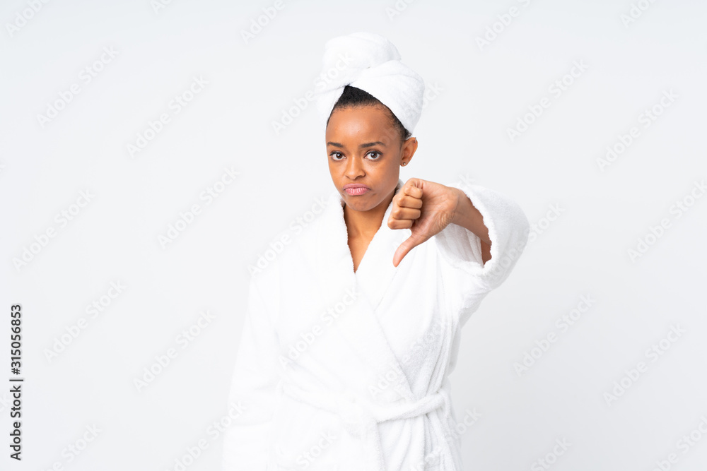 African american woman in a bathrobe over isolated background showing thumb down sign African american woman in a bathrobe over isolated background showing thumb down sign