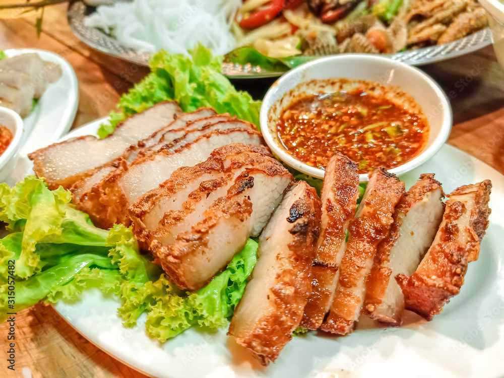 tasty slice Grilled pork or Pork Neck and belly Grilled , most popular traditional and Recommended Menu Thai food. The most delicious Grilled Pork Neck with Thai Spicy Sauce. Popular menu in Thailand.