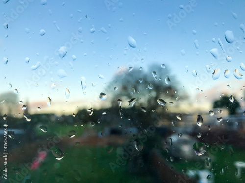 Looking out through a windows which is covered in rain drops.