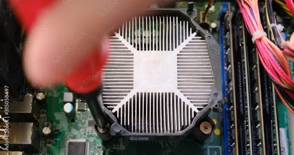Tightening screw of a CPU heatsink placed on a computer motherboard