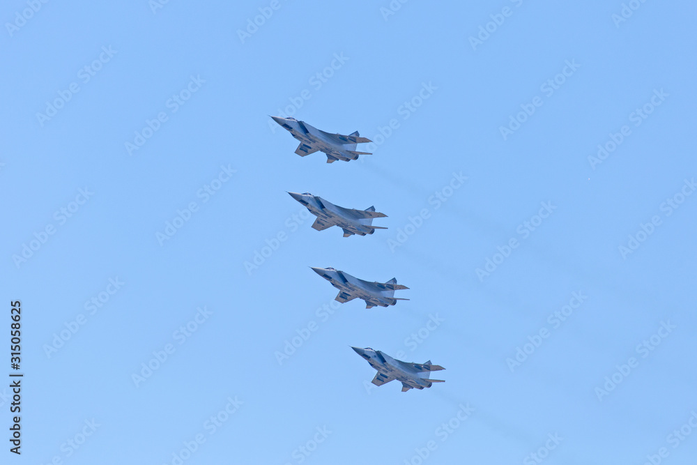 Russian Military jet in the air. Silhouettes of russian fighter aircrafts in the sky. military aircrafts flying together in the sky during airshow Russian Military jet in the air. Silhouettes of russian fighter aircrafts in the sky. military aircrafts flying together in the sky during airshow