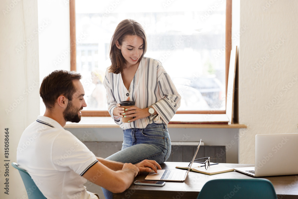 Smiling young couple working on a project