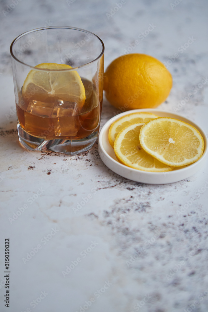 Whiskey sour drink with lemon in glass on stone rustical background Whiskey sour drink with lemon in glass on stone rustical background