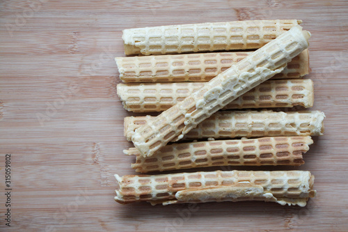 Homemade wafer rolls on cutting desk. Traditional russian cuisine. Close-up photo, space for text.