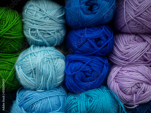 Different color woolen threads for knitting. Colored balls of yarn.