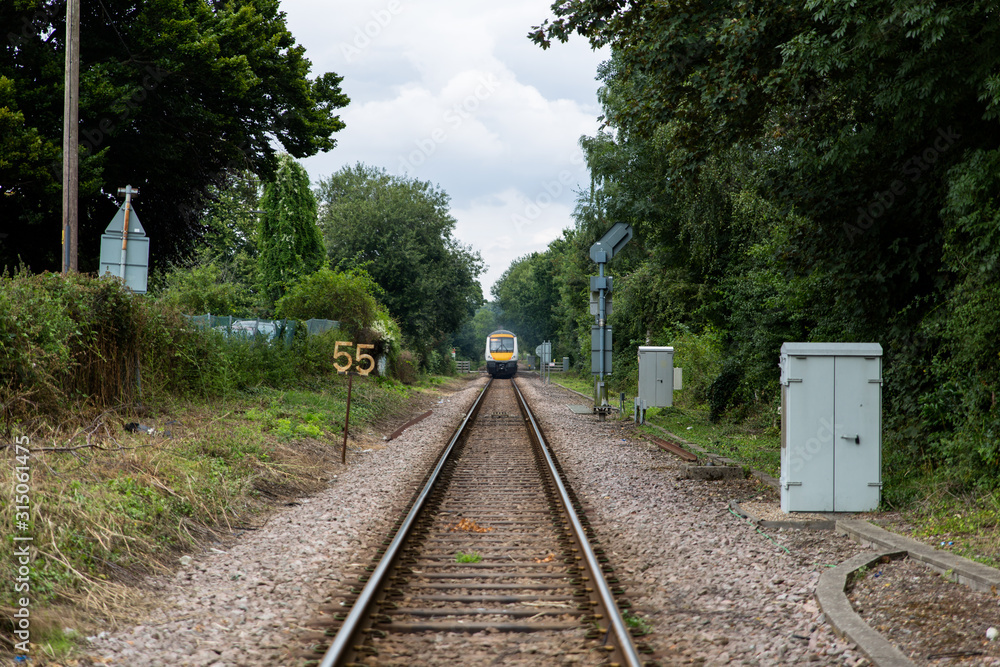 Fototapeta premium Passenger train on the tracks leaving or arriving at the station
