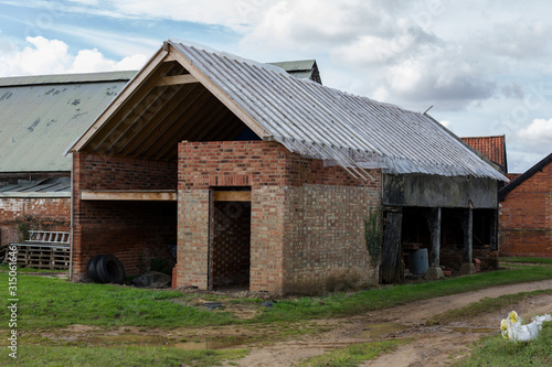 An old barn building that is currently being renovated and converted for a new use and lease of life on a farm