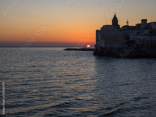 Silhouette of the church and the houses over the sea © Ancoay