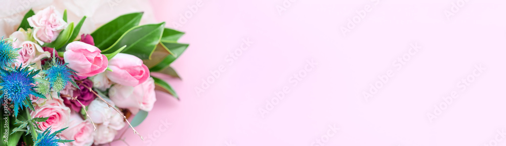 A closeup bouquet of roses and tulips decorated with leaves and twigs of other beautiful plants. Holiday concept. Flowers for Mother's Day. Copy space. A closeup bouquet of roses and tulips decorated with leaves and twigs of other beautiful plants. Holiday concept. Flowers for Mother's Day. Copy space.