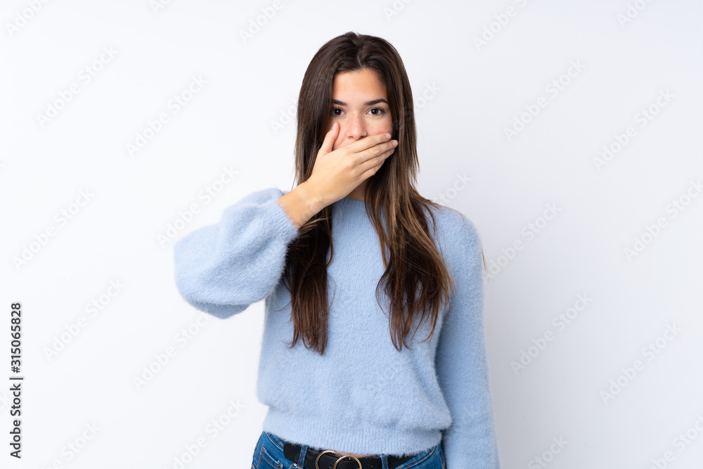 Teenager girl over isolated white background covering mouth with hands Teenager girl over isolated white background covering mouth with hands