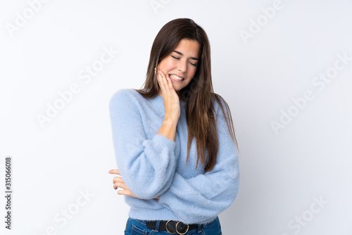 Teenager girl over isolated white background with toothache