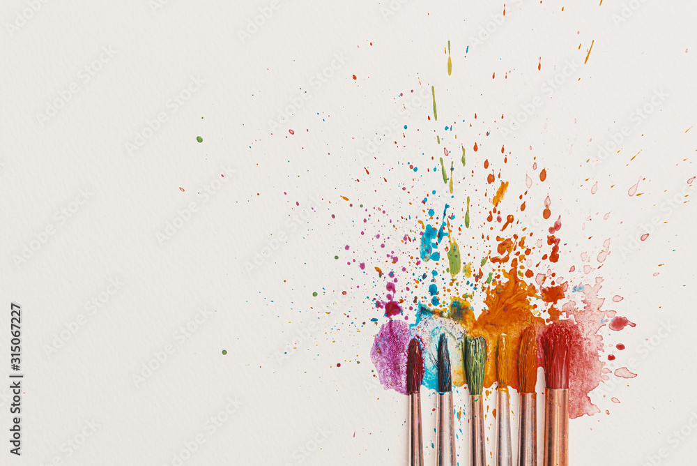 watercolor brushes on white paper