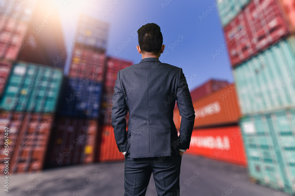 The abstract image of engineer standing in the container yard during sunrise. the concept of engineering, shipping, shipyard, business and transportation. The abstract image of engineer standing in the container yard during sunrise. the concept of engineering, shipping, shipyard, business and transportation.