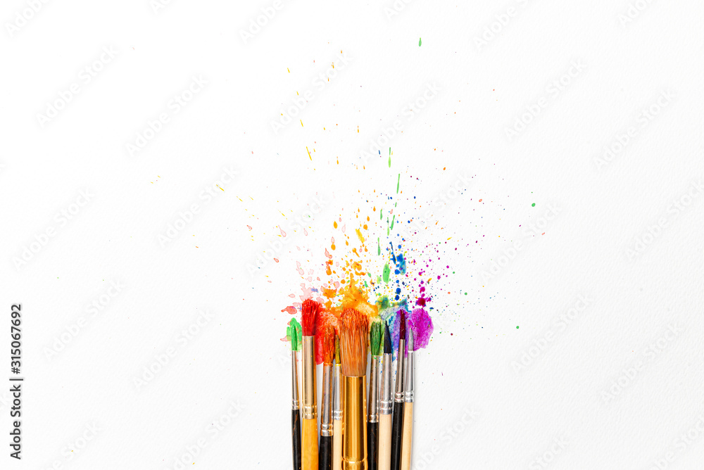 watercolor brushes on white paper