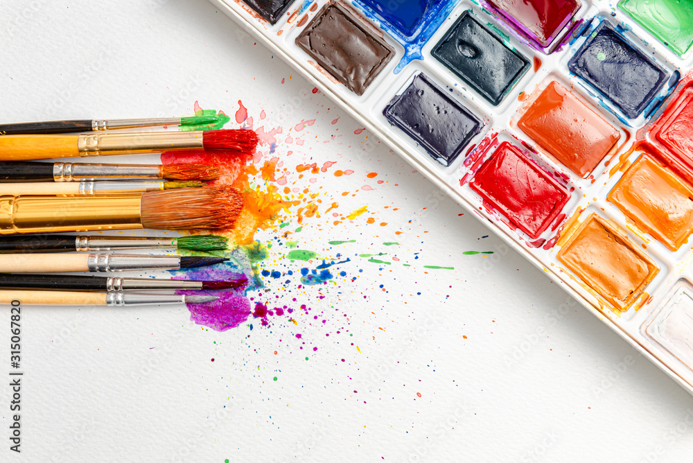 watercolor brushes on white paper