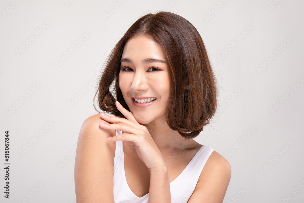 Beautiful Young Asian Woman with short hair Looking While Touching Chin feeling so happy and cheerful with healthy Clean and Fresh skin,isolated on white background,Beauty Cosmetics Concept Beautiful Young Asian Woman with short hair Looking While Touching Chin feeling so happy and cheerful with healthy Clean and Fresh skin,isolated on white background,Beauty Cosmetics Concept