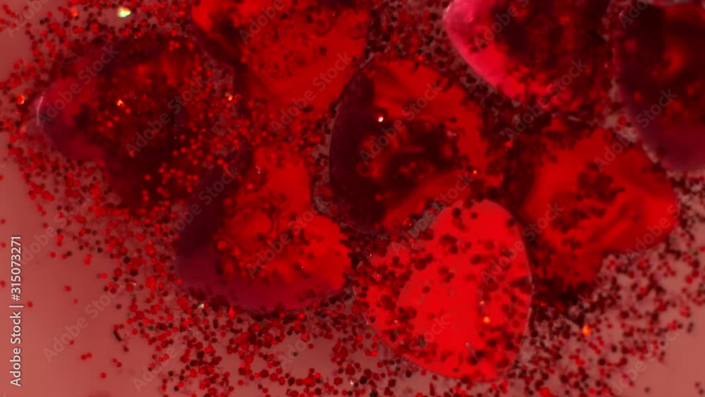 Beautiful red heart gems on clear water - Macro shot Beautiful red heart gems on clear water - Macro shot