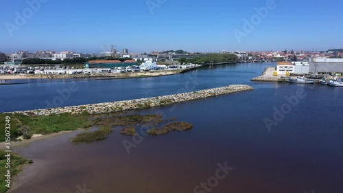 Aerial crane shot reveals docks in Ave river estuary in Vila do Conde, Portugal photo