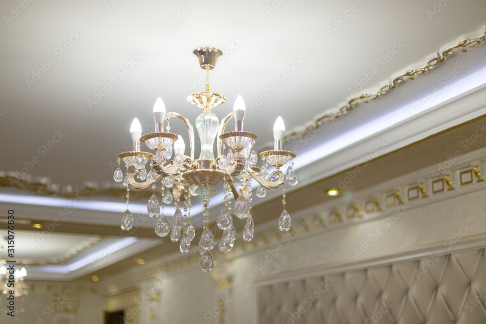 a large and beautiful chandelier hangs on the ceiling of the palace a large and beautiful chandelier hangs on the ceiling of the palace
