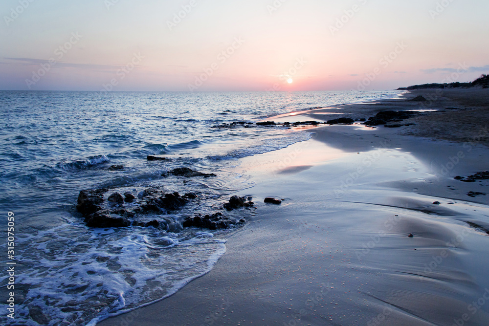 Sunset on the Pescoluse beach, Apulia, Italy