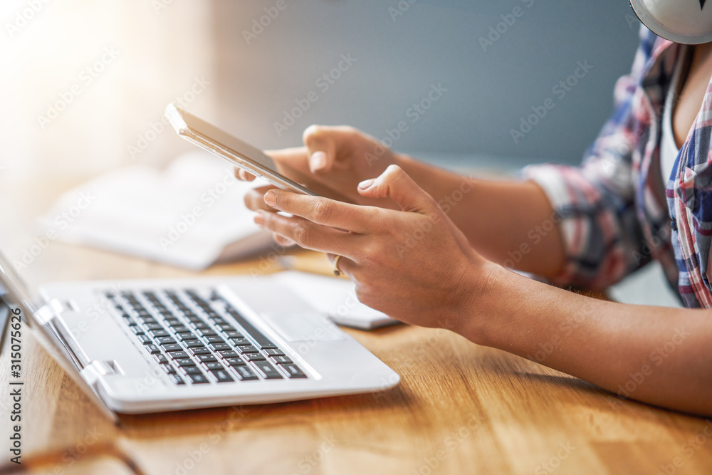 Midsection of female student learning at home Midsection of female student learning at home