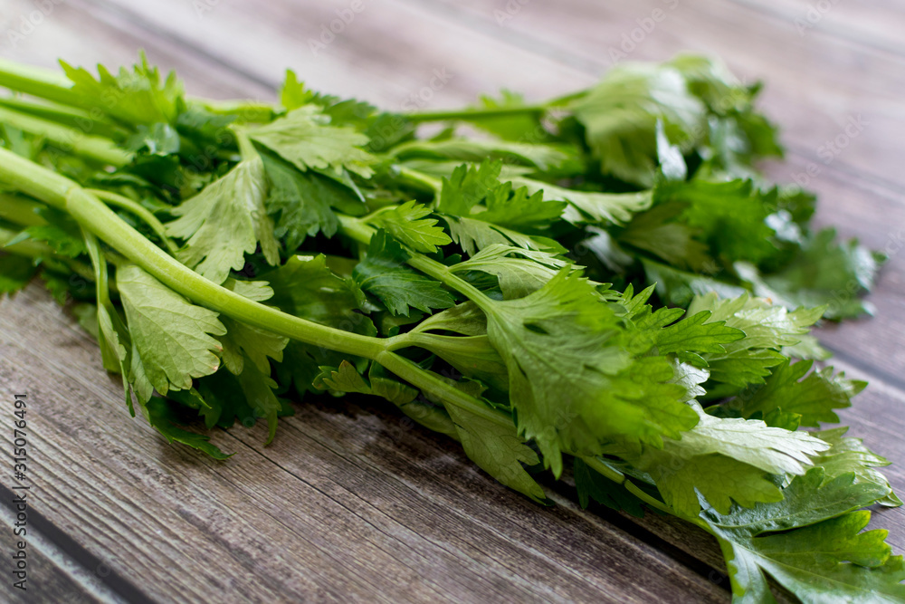 Close up fresh celery on old wooden background Close up fresh celery on old wooden background