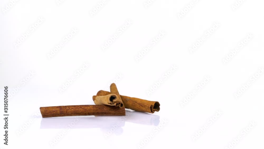 Ginger and cinnamon rotating on white background Ginger and cinnamon rotating on white background