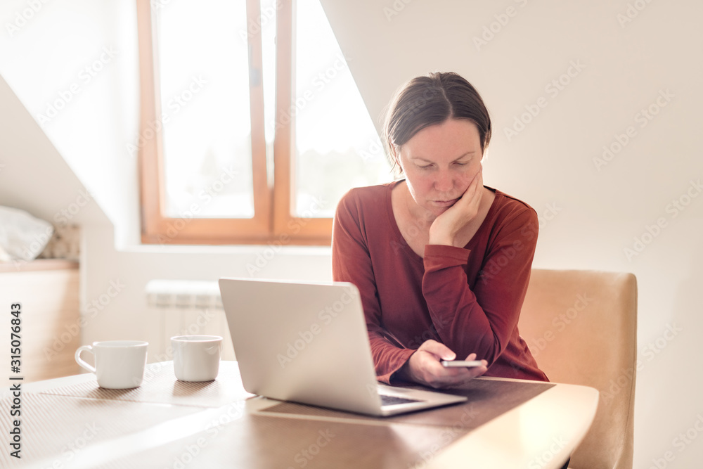 Woman telecommuting in home office interior Woman telecommuting in home office interior