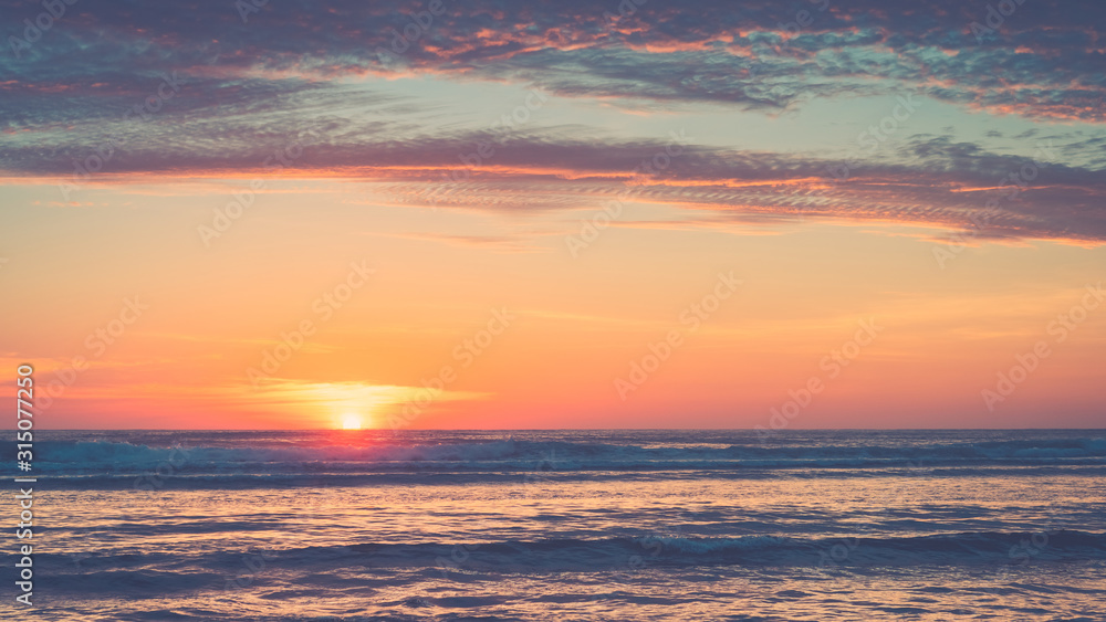 Fototapeta premium Tropical beach with smooth wave and sunset sky abstract background.