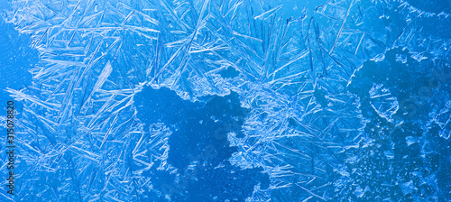 Abstract ice flowers pattern, frosted window macro view background. cold winter weather xmas backdrop