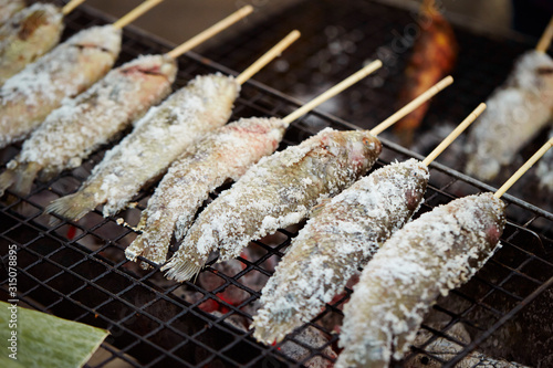 Salted fish skewer on grill 