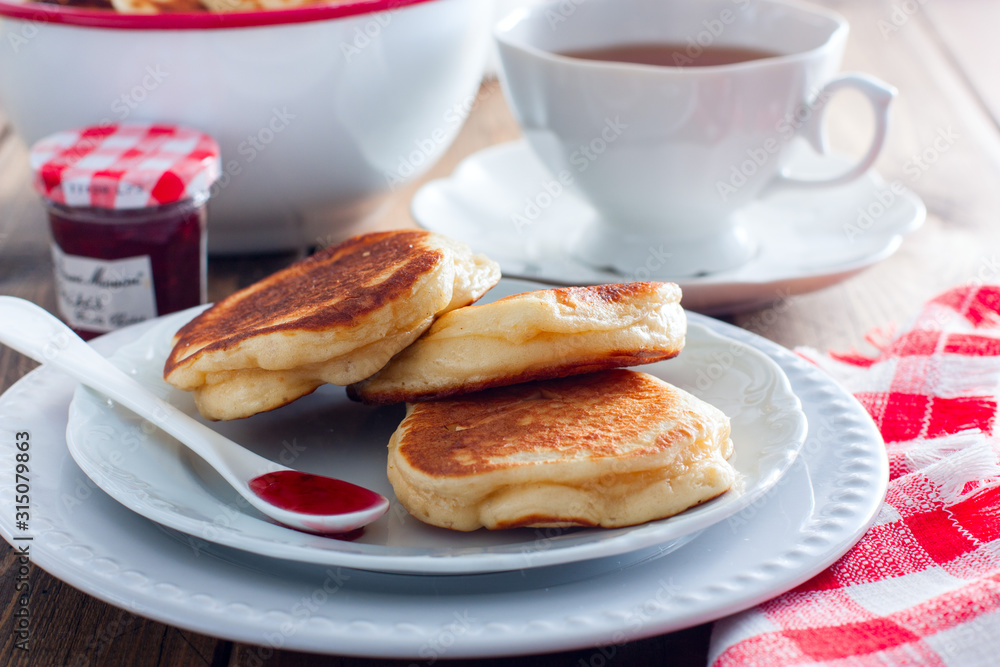 Homemade pancakes with apples on a wooden table, selective focus Homemade pancakes with apples on a wooden table, selective focus