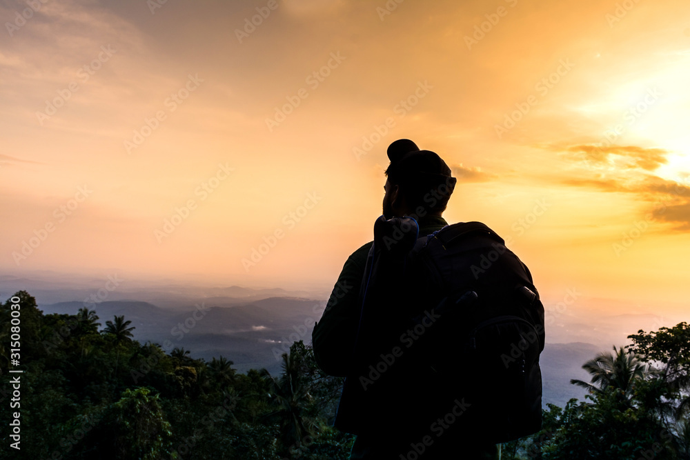 A man looking the scenic nature beauty of Kerala, Travel and Tourism Concept Image, Amazing sunset view from Vazhamala Kannur