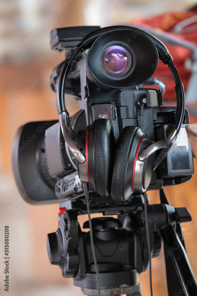 Video camera Stand on the stand with headphones Video camera Stand on the stand with headphones