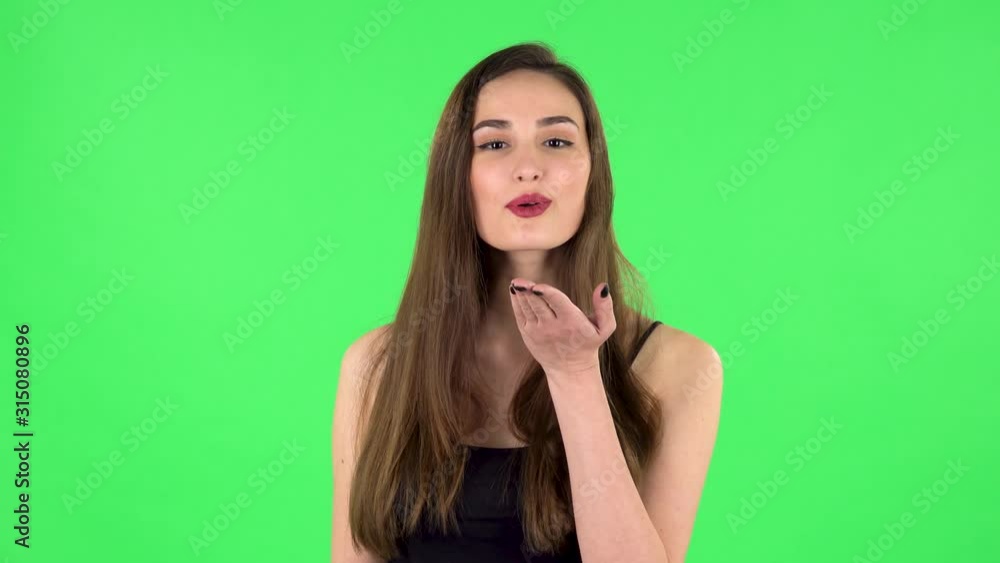 Cute girl smiles and showing blowing kiss. Green screen Cute girl smiles and showing blowing kiss. Green screen