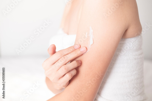 Woman applying arm cream lotion   Hygiene skin body care concept..