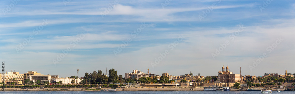 Luxor, Egypt, Karnak Temple, complex of Amun-Re. View of the ancient city of Thebes from the Nile. Panoramic city, view from the river.