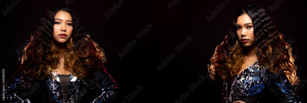 Fototapeta premium Portrait of Fashion Asian Woman has beautiful brown black long curl hair style from Stylish. Girl wears Blue Gown and swing throw her hair to side air over dark Background copy space text logo