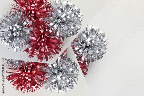 Holiday composition. Beautiful shiny bows on a gray background, gift decorated. Holiday concept. Top view, flat lay, mock up, mockup, copy space.