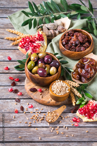Tu Bishvat holiday symbols - dried fruits, pomegranate, barley, wheat