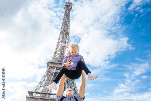 Family father and daughter happy and cheerful in Paris against the background of the Eiffel tower © kuzmichstudio