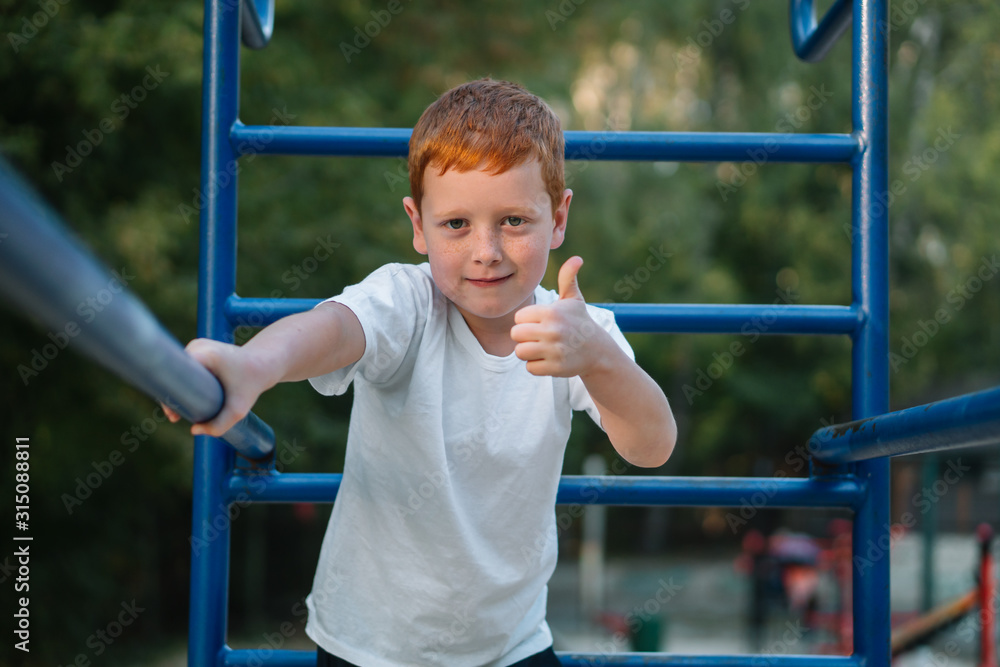 Little boy playing sports on street public sports simulators Little boy playing sports on street public sports simulators