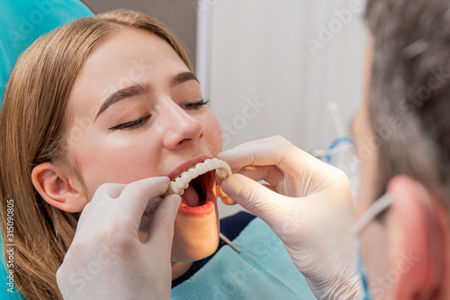 doctor tries on a denture