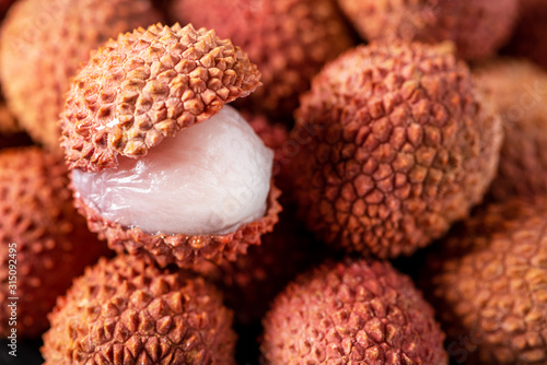Fruits lychee background. Sliced lychee with white flesh closeup. Litchi chinensis