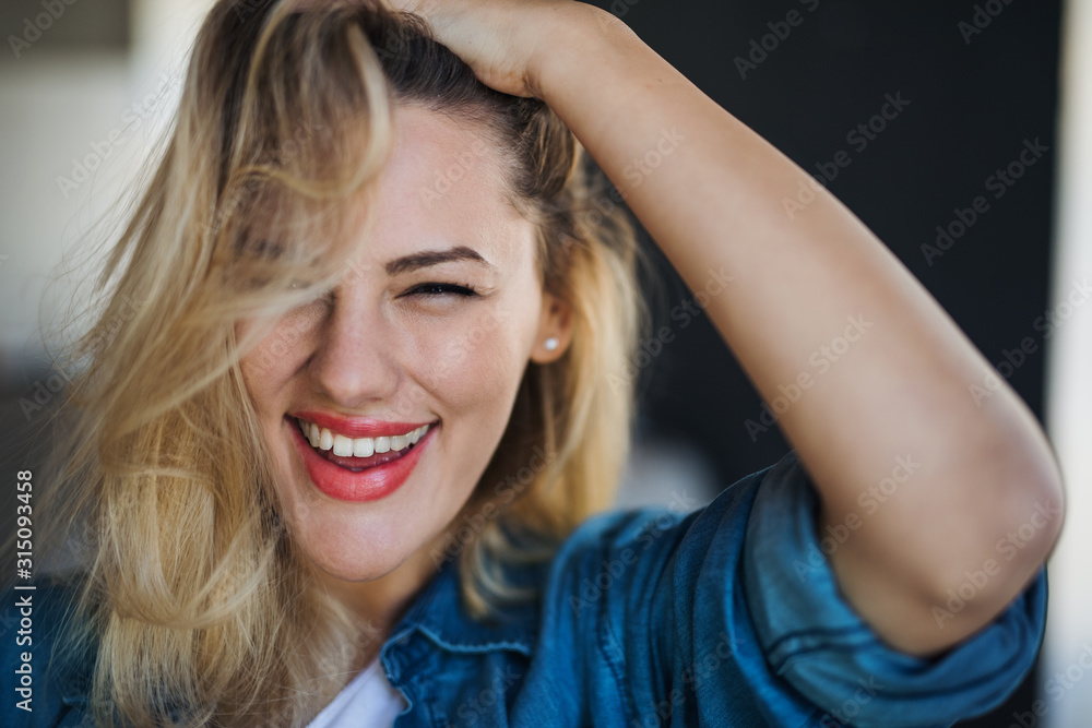 Close-up portrait of cheerful young woman indoors at home. Close-up portrait of cheerful young woman indoors at home.