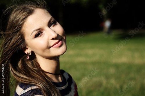 Outdoors portrait of a beautiful young woman smiling