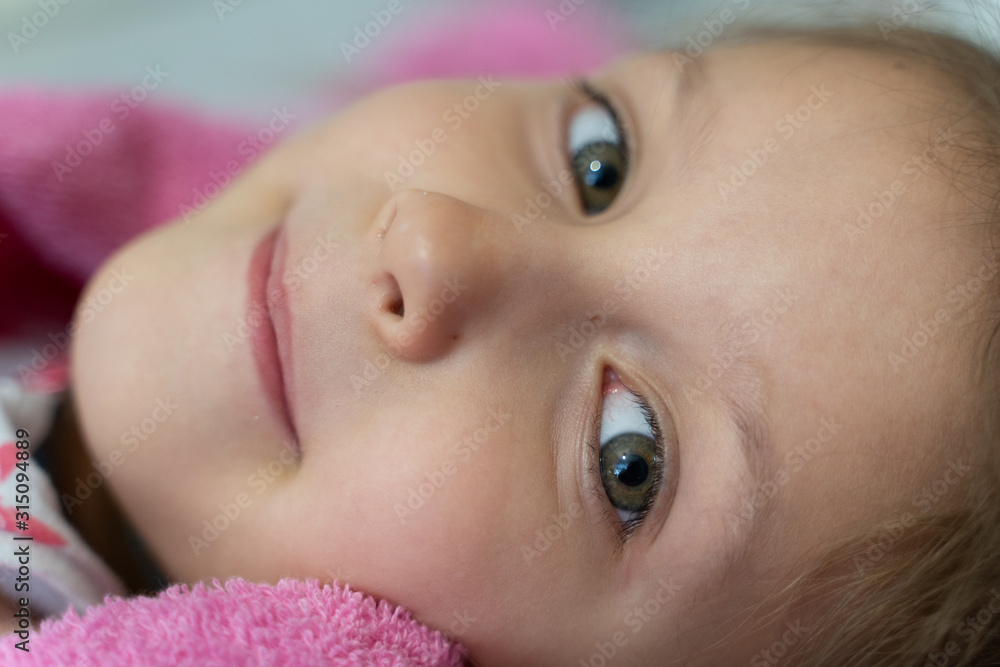 Girl child in a pink bathrobe